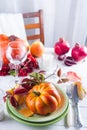 Autumn Halloween or thanksgiving day table setting. Fallen leaves, pumpkins, spices, empty plate and cutlery on wooden Royalty Free Stock Photo