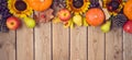 Autumn harvest concept with pumpkin, apples and sunflowers on wooden table Royalty Free Stock Photo