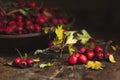 Autumn harvest Hawthorn berry with leaves in bowl on a wooden ta