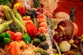 Autumn harvest. Pears, plums, apple, grapes and yellow leaves on the wooden table Royalty Free Stock Photo