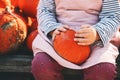 Autumn harvest of pumpkins. Child picking orange pumpkin at farm market or seasonal festival. Cute little girl playing among Royalty Free Stock Photo