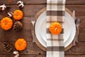 Autumn harvest or thanksgiving dinner table setting, top view on a rustic wood background Royalty Free Stock Photo