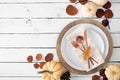 Autumn harvest or thanksgiving dinner table setting with plates, flatware, napkin, fall decor and copy space Royalty Free Stock Photo