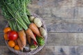 Vegetable basket on a wooden table, in rustic style. Royalty Free Stock Photo