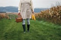 Woman farmer holding wicker basket and harvested corn cob Royalty Free Stock Photo