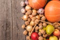 Autumn harvests arranged od the right side of the frame on old wooden boards. Top view of vegetables and fruits. Free space. Royalty Free Stock Photo