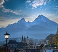 Autumn hazy evening famous Bavarian prealps Berchtesgaden town and mount Watzmann silhouette in contra light, Germany