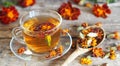 Autumn healing background. Folk medicine Glass of herbal tea with marigold flowers on wooden ancient background with dried flowers Royalty Free Stock Photo