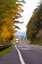 Autumn highway road with semi truck and yellow trees Royalty Free Stock Photo