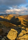 Autumn hiking in the mountains with massive rocks, dramatic skies and majestic mountains.