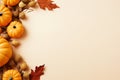Autumn holiday composition with pumpkins, nuts and dry leaves on paper beige color background. Fall harvest, Halloween,
