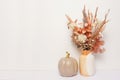 Autumn home still life of dry flowers in vase and golden pumpkin on white background, copy space Royalty Free Stock Photo