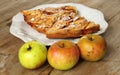 Autumn homemade apple pie - charlotte. on white ceramic plate on wooden background with fresh apples Royalty Free Stock Photo