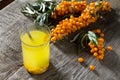 Autumn hot drink. Tea with sea-buckthorn berries branch on vintage wooden background Royalty Free Stock Photo