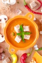 Autumn hot pumpkin soup with croutons and mint in pumpkin shaped bowl