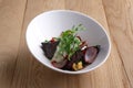 Autumn hot salad with deep fried beetroot, onion, tomato and nuts