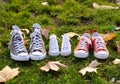 Autumn image of family shoes sneakers gumshoes on grass in sunset light in outdoors family lifestyle