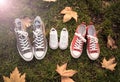 Autumn image of family shoes sneakers gumshoes on grass in sunset light in outdoors family lifestyle