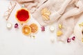 Autumn-Inspired sweater weather background - hot beverage with pumpkin tea cup among dry roses, leaves and candles.