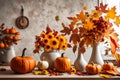 Autumn kitchen interior. Red and yellow leaves and flowers in the vase and pumpkin on light background Royalty Free Stock Photo