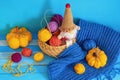 Autumn knitting and hobby concepts. Yellow knitted pumpkins, colorful balls of wool and funny gnome