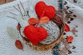 Autumn knitting of warm clothes. Woolen balls of knitting needles knitted hearts. Self-made things with love. Idea for