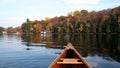 Autumn lake reflection with a canoe