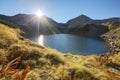 Autumn lake scenery with bright sunlight shining above Mount Tateyama Royalty Free Stock Photo