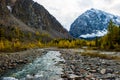 Autumn landscape with the Aktru river and Karatash peak. Altai mountains in cloudy weather. Siberia. Russia Royalty Free Stock Photo