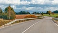 Autumn landscape with asphalt road and forest. Royalty Free Stock Photo