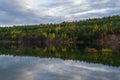 Autumn landscape. Blue calm lake surrounded by colorful autumn forest Royalty Free Stock Photo