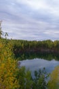 Autumn landscape. Blue calm lake surrounded by colorful autumn forest Royalty Free Stock Photo