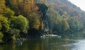 Autumn landscape with Cockerel rock of mountain river Psekups. People ride pedal catamarans Sunny day in resort area