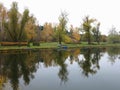 Autumn landscape with colorful forest, lake, reflection and a bo Royalty Free Stock Photo