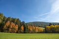 Autumn landscape in Dolomites, Italy, near the village of Braies. Mountains, fir trees and larches that change color assuming the Royalty Free Stock Photo