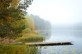 Autumn landscape in the early foggy morning on a beautiful lake with water lilies. Royalty Free Stock Photo