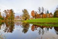 Autumn landscape - Fedorovskiy Gorodok and yellow trees reflected in a mirror pond in the town of Pushkin