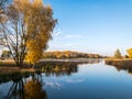Autumn landscape. forest lake with colorful trees and water surface with sky reflections Royalty Free Stock Photo