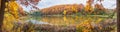 Autumn landscape - the forest by lake in the sunny autumn day Royalty Free Stock Photo