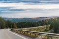 Autumn landscape. On the freeway. Travel by car. A sharp turn and bumpers along the road. A beautiful autumn forest along the road Royalty Free Stock Photo