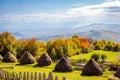 Autumn landscape with haystacks and mountains in the distance Royalty Free Stock Photo