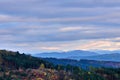 Autumn mountain landscape with forest and colorful sky at sunset. Royalty Free Stock Photo