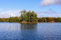 Autumn landscape with lake and small island.  Calm nature in the fall season Royalty Free Stock Photo