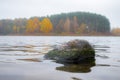 Autumn landscape: lake, forest, stone