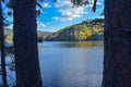 Autumn landscape with a lake in the forest, trees and blue sky, Royalty Free Stock Photo