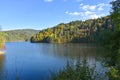 Autumn landscape with a lake in the forest, trees and blue sky, Royalty Free Stock Photo