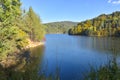 Autumn landscape with a lake in the forest, trees and blue sky, Royalty Free Stock Photo