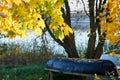 Autumn landscape with lake and inverted boat Royalty Free Stock Photo