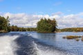 Autumn landscape with lake and small island. View from boat Calm nature in the fall season Royalty Free Stock Photo
