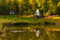 Autumn landscape with lake and stone water mill. Royalty Free Stock Photo